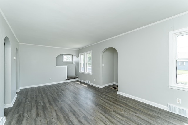 213 11th St SE, Rochester, MN 55904 - empty room with arched walkways, dark wood-type flooring, and crown molding