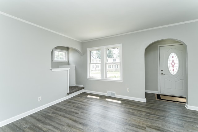 213 11th St SE, Rochester, MN 55904 - unfurnished living room featuring arched walkways, crown molding, plenty of natural light, and wood finished floors