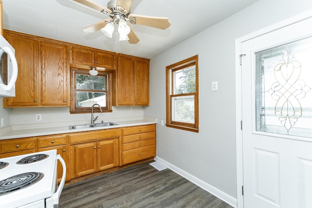 213 11th St SE, Rochester, MN 55904 - kitchen featuring white appliances, dark wood finished floors, brown cabinetry, and light countertops