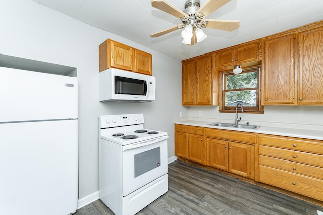 213 11th St SE, Rochester, MN 55904 - kitchen with white appliances, dark wood-type flooring, light countertops, brown cabinetry, and ceiling fan