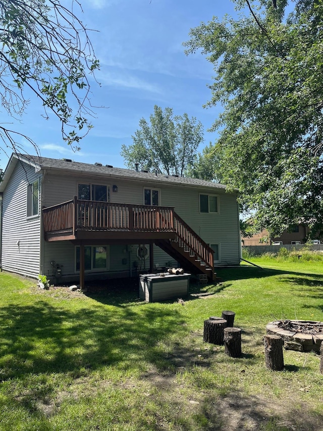 825 10th Ave SW, Forest Lake, MN 55025 - rear view of house featuring an outdoor fire pit, a deck, stairs, and a lawn