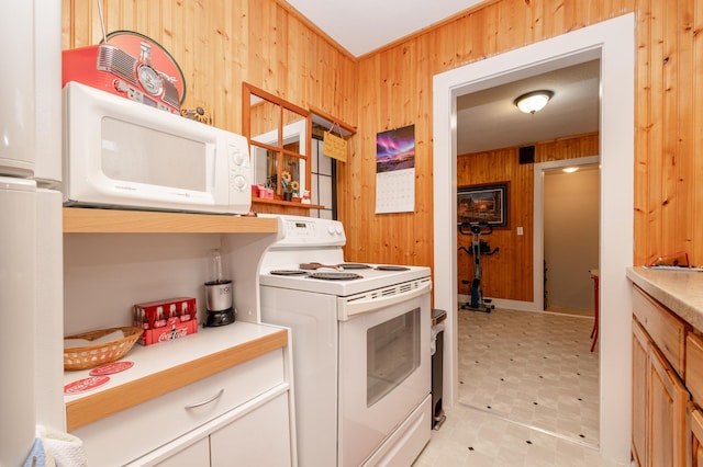 600 1st Ave, Osakis, MN 56360 - kitchen with wood walls, white appliances, light flooring, and light countertops