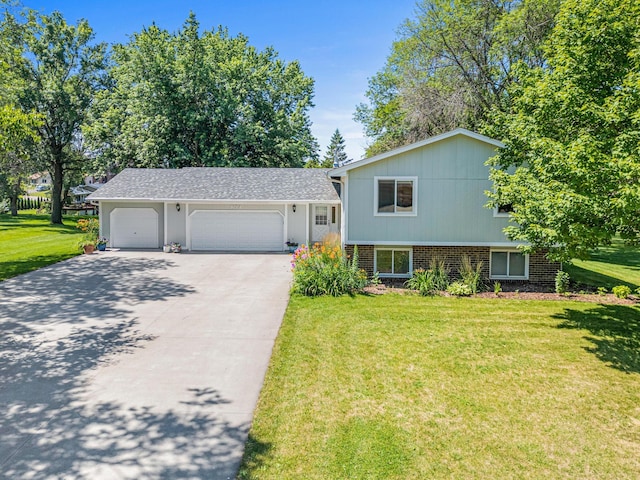 16951 88th Ave N, Maple Grove, MN 55311 - split level home featuring brick siding, a front lawn, driveway, and a garage