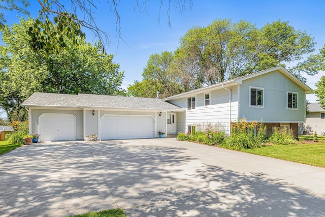 16951 88th Ave N, Maple Grove, MN 55311 - split level home featuring driveway, brick siding, and a garage