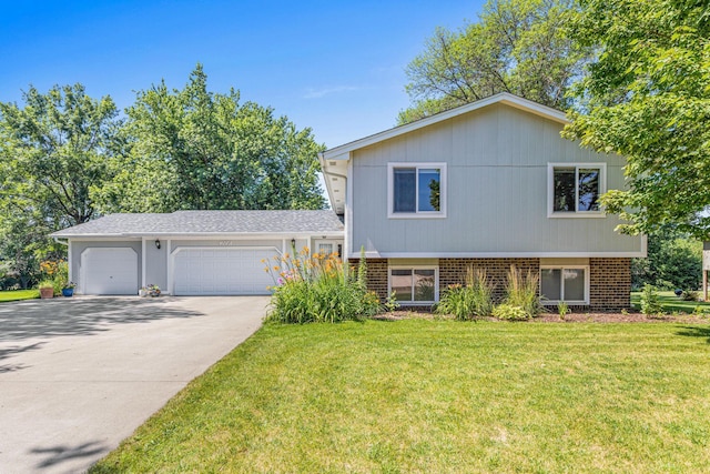 16951 88th Ave N, Maple Grove, MN 55311 - split level home with a front lawn, concrete driveway, and brick siding