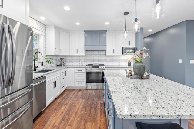 16951 88th Ave N, Maple Grove, MN 55311 - kitchen with appliances with stainless steel finishes, dark wood finished floors, a center island, white cabinets, and recessed lighting