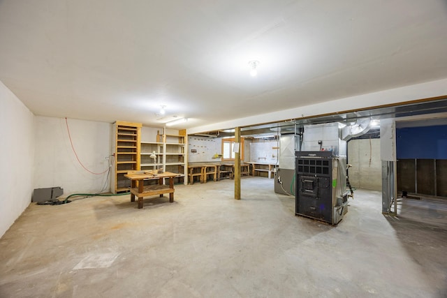 23865 County Rd, Loretto, MN 55357 - unfinished basement featuring heating unit and a workshop area