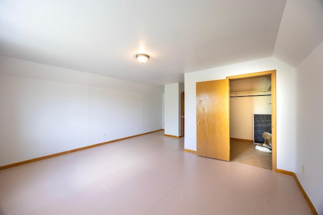 23865 County Rd, Loretto, MN 55357 - unfurnished bedroom featuring finished concrete floors and a spacious closet