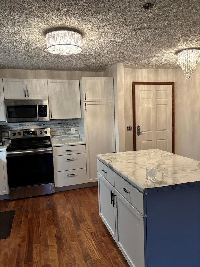 13670 Carrach Ave Unit 214, Rosemount, MN 55068 - kitchen featuring stainless steel appliances, a textured ceiling, dark wood-style flooring, white cabinetry, and backsplash