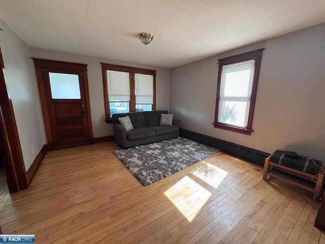 1027 Chapman St, Ely, MN 55731 - living room featuring healthy amount of natural light, baseboard heating, and light wood-type flooring