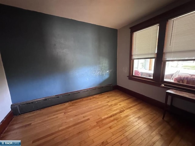 1027 Chapman St, Ely, MN 55731 - empty room with baseboard heating and light wood finished floors