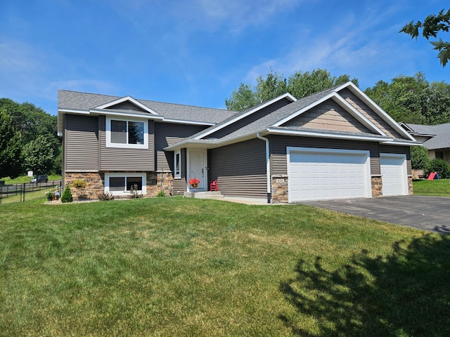 655 Glenmeadow St, River Falls, WI 54022 - view of front of house featuring driveway, stone siding, an attached garage, and a shingled roof