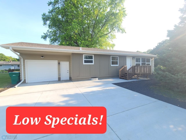 327 Mickey Mouse Ave, Horace, ND 58047 - ranch-style house with driveway, a garage, a shingled roof, and board and batten siding