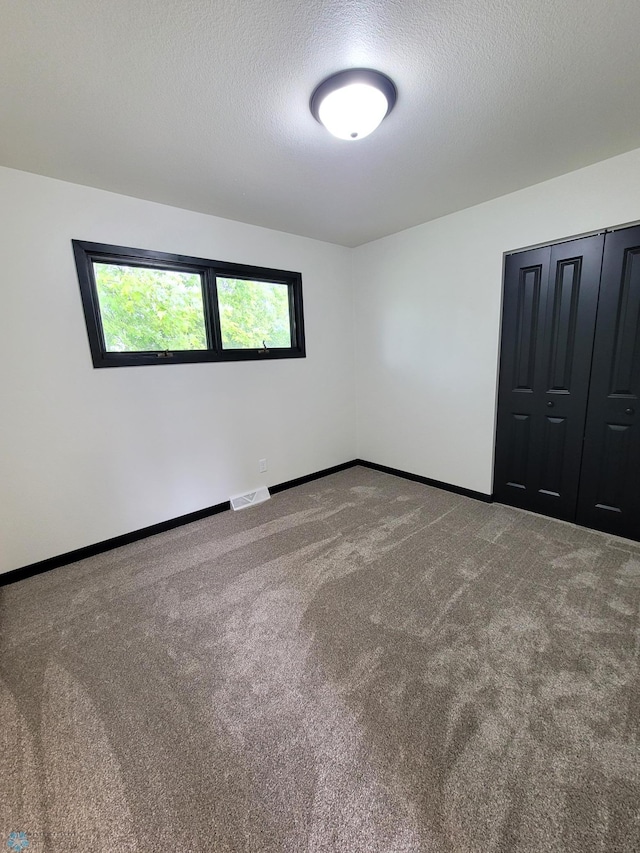 327 Mickey Mouse Ave, Horace, ND 58047 - carpeted empty room with baseboards and a textured ceiling
