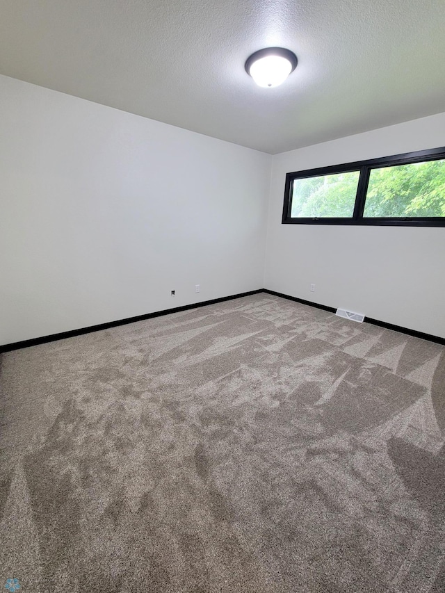 327 Mickey Mouse Ave, Horace, ND 58047 - carpeted empty room featuring a textured ceiling and baseboards