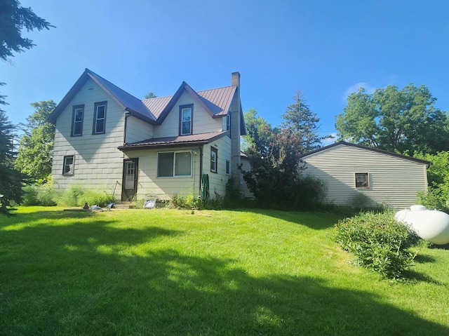 211 2nd St, Hatfield, MN 56164 - back of house featuring a chimney, a lawn, and a metal roof