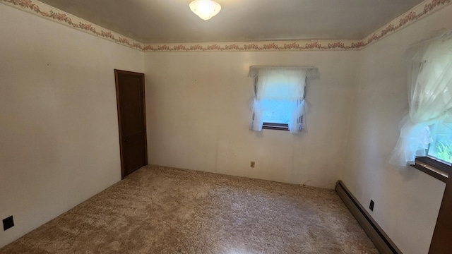 211 2nd St, Hatfield, MN 56164 - empty room with a baseboard radiator, healthy amount of natural light, and carpet floors