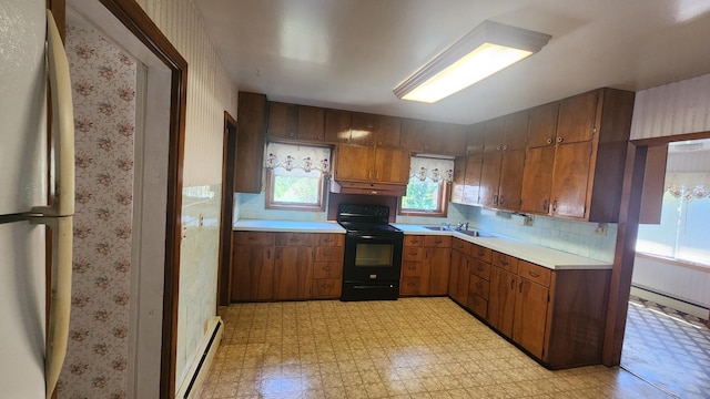 211 2nd St, Hatfield, MN 56164 - kitchen featuring black electric range oven, light countertops, freestanding refrigerator, healthy amount of natural light, and wallpapered walls