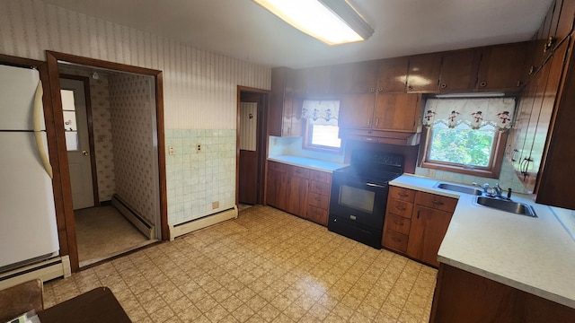 211 2nd St, Hatfield, MN 56164 - kitchen with black range with electric stovetop, light countertops, wallpapered walls, and light flooring