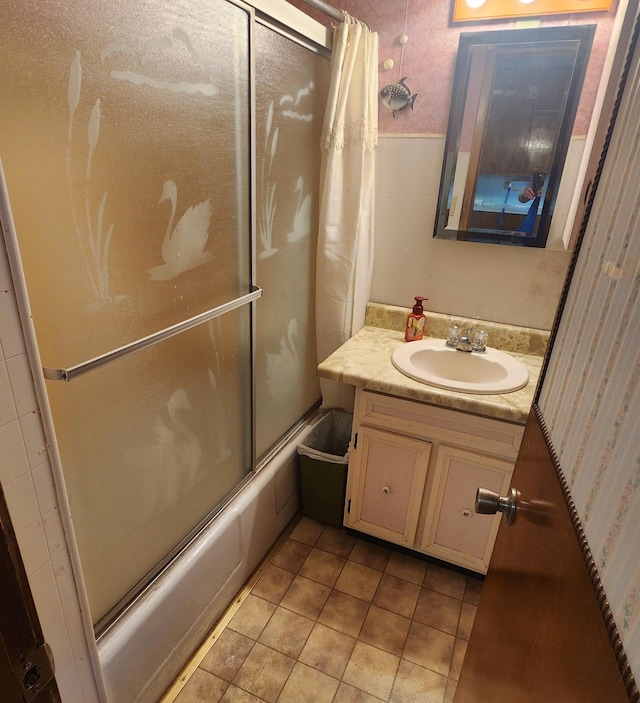 211 2nd St, Hatfield, MN 56164 - bathroom featuring combined bath / shower with glass door, vanity, wallpapered walls, tile patterned flooring, and wainscoting
