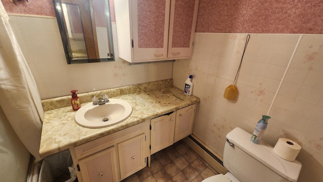 211 2nd St, Hatfield, MN 56164 - bathroom featuring tile walls, vanity, and baseboard heating