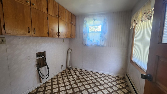 211 2nd St, Hatfield, MN 56164 - washroom featuring cabinet space, plenty of natural light, a baseboard radiator, and light flooring