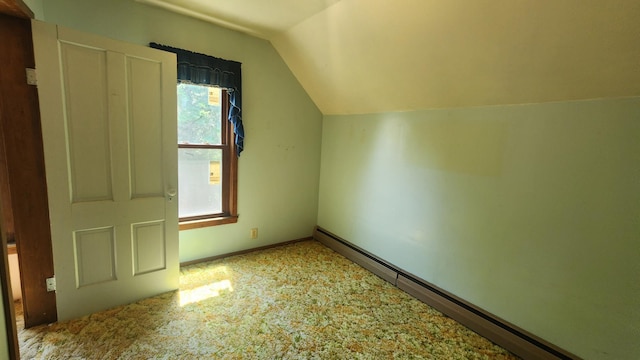 211 2nd St, Hatfield, MN 56164 - additional living space featuring a baseboard heating unit, vaulted ceiling, and carpet flooring