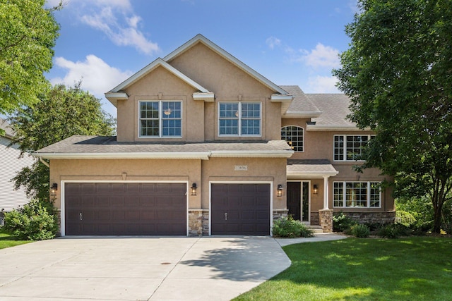 13836 Clare Downs Way, Rosemount, MN 55068 - view of front facade with driveway, stone siding, stucco siding, a front lawn, and a garage
