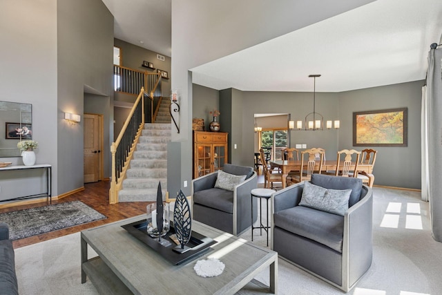 13836 Clare Downs Way, Rosemount, MN 55068 - carpeted living room with stairs, a high ceiling, and a chandelier
