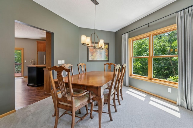 13836 Clare Downs Way, Rosemount, MN 55068 - carpeted dining space with a chandelier and baseboards