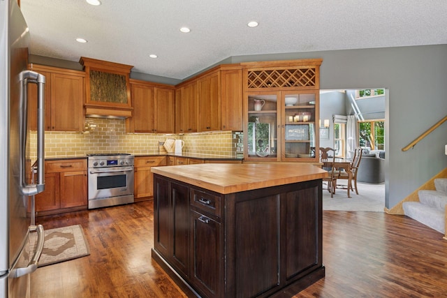 13836 Clare Downs Way, Rosemount, MN 55068 - kitchen featuring butcher block countertops, appliances with stainless steel finishes, backsplash, dark wood finished floors, and glass insert cabinets