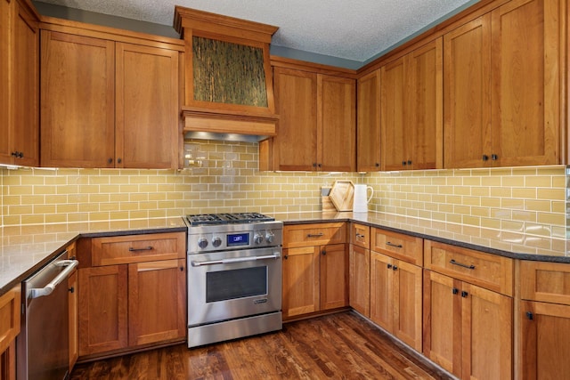 13836 Clare Downs Way, Rosemount, MN 55068 - kitchen with appliances with stainless steel finishes, brown cabinets, dark wood-style floors, and a textured ceiling