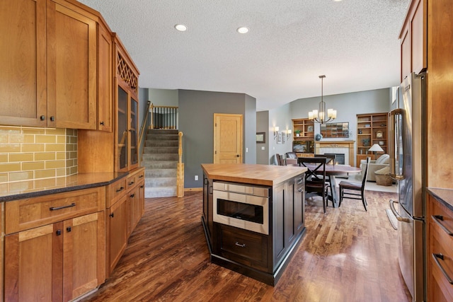 13836 Clare Downs Way, Rosemount, MN 55068 - kitchen with a textured ceiling, butcher block countertops, dark wood-type flooring, backsplash, and freestanding refrigerator