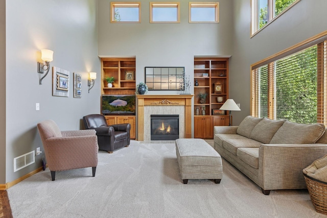 13836 Clare Downs Way, Rosemount, MN 55068 - living room with a high ceiling, a tiled fireplace, and carpet flooring