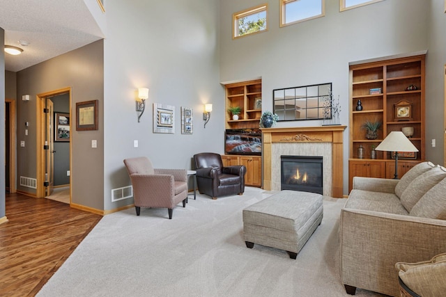 13836 Clare Downs Way, Rosemount, MN 55068 - living area with a towering ceiling, a fireplace, and wood finished floors