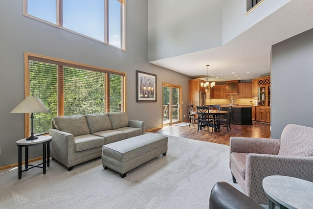 13836 Clare Downs Way, Rosemount, MN 55068 - living room featuring a chandelier, a high ceiling, and wood finished floors