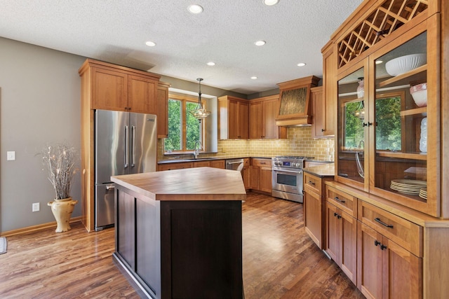 13836 Clare Downs Way, Rosemount, MN 55068 - kitchen featuring wood counters, high quality appliances, decorative backsplash, wood finished floors, and recessed lighting