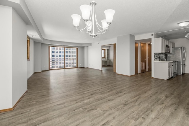 66 9th St E Unit 2315, Saint Paul, MN 55101 - unfurnished living room with a chandelier and wood finished floors