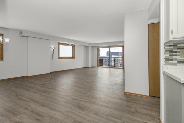 66 9th St E Unit 2315, Saint Paul, MN 55101 - unfurnished living room featuring wood finished floors and baseboards