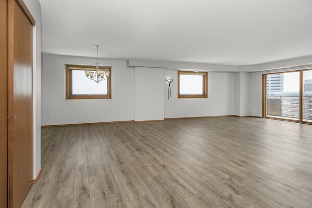 66 9th St E Unit 2315, Saint Paul, MN 55101 - unfurnished room with a chandelier and light wood-style floors