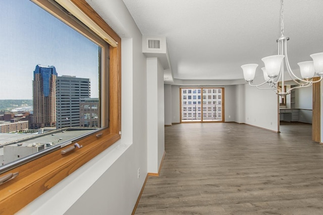 66 9th St E Unit 2315, Saint Paul, MN 55101 - corridor featuring a chandelier, wood finished floors, and healthy amount of natural light
