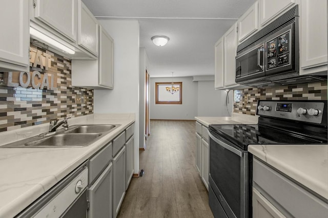 66 9th St E Unit 2315, Saint Paul, MN 55101 - kitchen featuring electric range, black microwave, backsplash, and light countertops