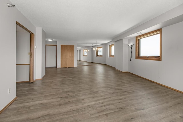 66 9th St E Unit 2315, Saint Paul, MN 55101 - spare room featuring light wood-type flooring and a chandelier