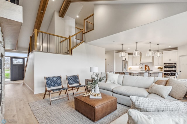 5820 31st St S, Fargo, ND 58104 - living area featuring high vaulted ceiling, stairs, light wood-style floors, recessed lighting, and beamed ceiling