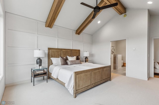 bedroom featuring ensuite bath, light colored carpet, ceiling fan, high vaulted ceiling, and beamed ceiling