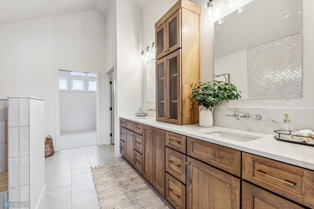 5820 31st St S, Fargo, ND 58104 - bathroom featuring double vanity, tile patterned floors, and a towering ceiling