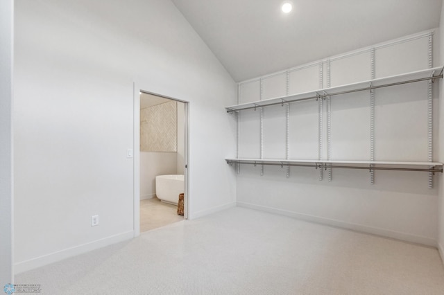 walk in closet with lofted ceiling