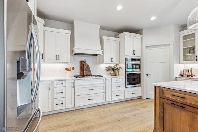 5820 31st St S, Fargo, ND 58104 - kitchen featuring stainless steel appliances, custom range hood, light countertops, white cabinetry, and recessed lighting