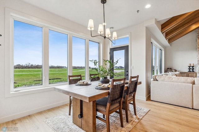 5820 31st St S, Fargo, ND 58104 - dining room featuring a chandelier, light wood finished floors, lofted ceiling, golf course view, and recessed lighting