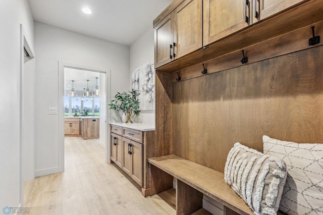 mudroom with light hardwood / wood-style floors